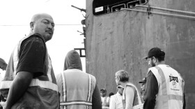 Longshoremen from the ILWU Local 29 gather for the morning safety briefing prior to boarding