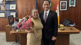 Maria Chavez (left), immigration legal director for the Partnership for the Advancement of New Americans, stands next to Mayor Todd Gloria as part of the city's "Women of Distinction" event, March 10, 2026.