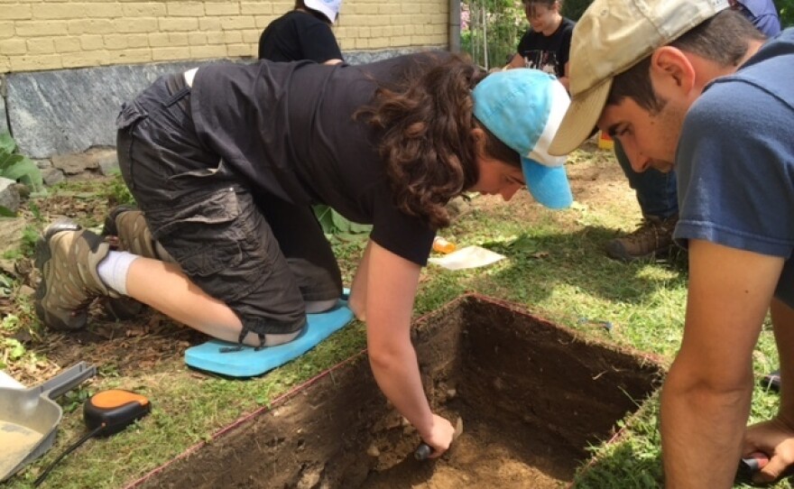 University of Massachusetts archaeologists are excavating the ground just outside Dickinson's yellow brick house to learn more about the conservatory that once stood there. Above, archaeology student Kate Barvick and program co-director Dan Zoto.