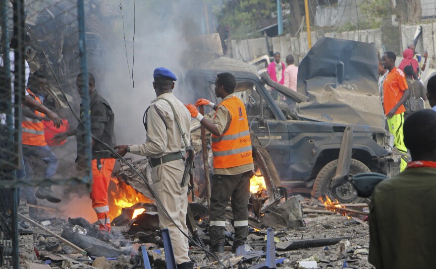 Somali soldiers inspect the wreckage of vehicles after an attack claimed by al-Shabab left at least 23 dead in Mogadishu on Saturday.