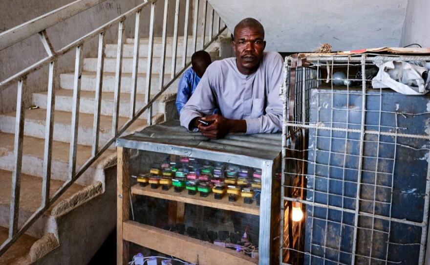 Modu Churi, who fled his village to escape Boko Haram last year, now earns a living by charging cellphones for displaced persons in northeast Nigeria.