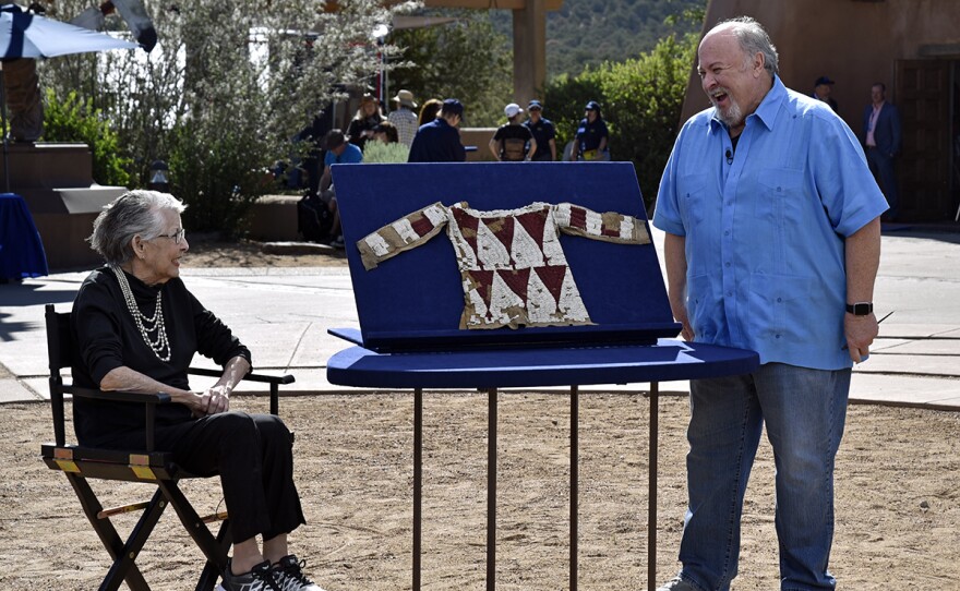 Bruce M. Shackelford (right) appraises a Plains Indian child’s beaded short, ca. 1850, in Santa Fe, N.M.