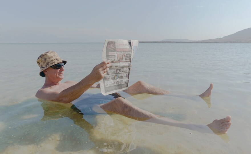 Gregory, a recent immigrant from Russia, floats in the Dead Sea at a beach connected to an Israeli hotel resort on Nov. 10. The water of the lake is so full of salt that bathers float right to the top.