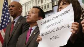 Assemblyman Chris Holden, D-Pasadena, left, and Assemblyman David Chiu, D-San Francisco, center, listen as proponents speak in support of their bills that would generally bar state agencies from denying licenses to an applicant because of prior arrests or convictions for nonviolent offenses, during a news conference, Monday, April 23, 2018, in Sacramento, Calif. 