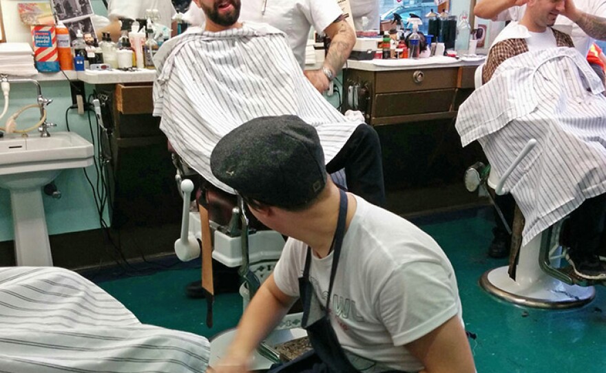 Customers get a shine and a haircut at the Nite Owl Barber Shop in Toronto, Canada.