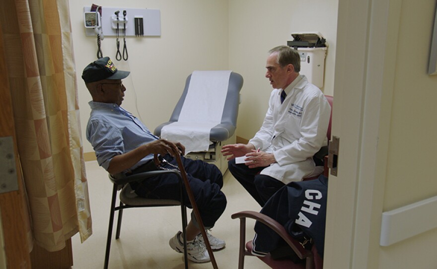 Dr. David Shulkin, Secretary of the U.S. Department of Veterans Affairs, speaks with patient at the VA hospital in New York City.
