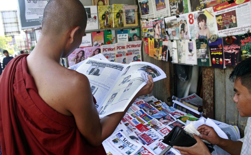 A Buddhist monk reads a newspaper in Yangon on Tuesday. Newspaper articles that would have been rejected by Myanmar's draconian state censors just months ago are making it into print, in one of many signs that the long-repressed country is becoming more open.