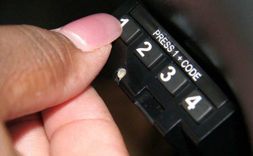 A borrower enters a code into a starter-interrupt device installed in a car in Limerick, Pa.