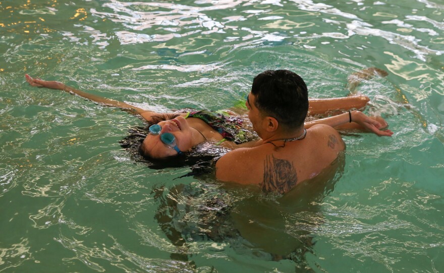 Agustin, Lola's father, teaches Lola how to float on her back at a hotel swimming pool on April 9, 2017. After four months of experimental chemo, Lola met her breaking point and ended the medical trial — a decision based on her quality of life. Revitalized, Lola gained the energy to enjoy her favorite activities again.