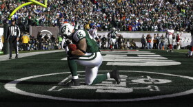 New York Jets tight end Josh Baker celebrates after scoring a touchdown during the first quarter in the game against the New York Giants in 2011.