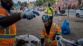 City crews clean up what's left of a homeless encampment near 19th and L Streets in San Diego on Friday, Aug. 15, 2025.