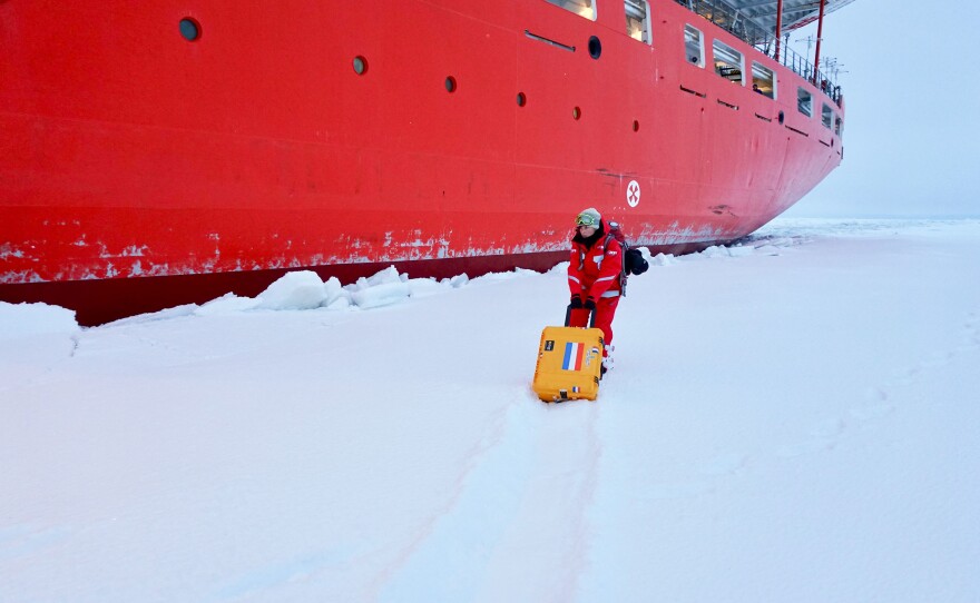 Scientist Jessie Creamean moves a portable aerosol sampler out onto the ice to test it in the cold conditions.