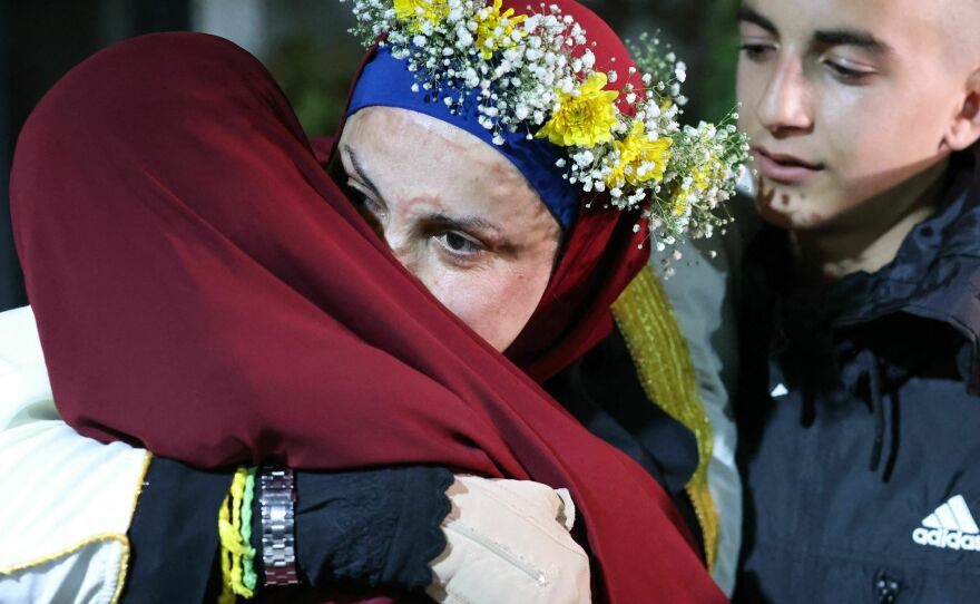 Relatives of prominent Palestinian prisoner Israa Jaabis, center, welcome her at her home in East Jerusalem early Sunday after detainees were released from Israeli jails in exchange for hostages released by Hamas.