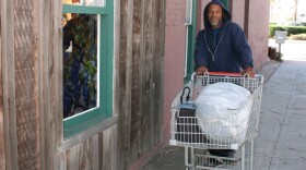 A homeless man walks on a street in Oceanside, Oct. 30, 2015.