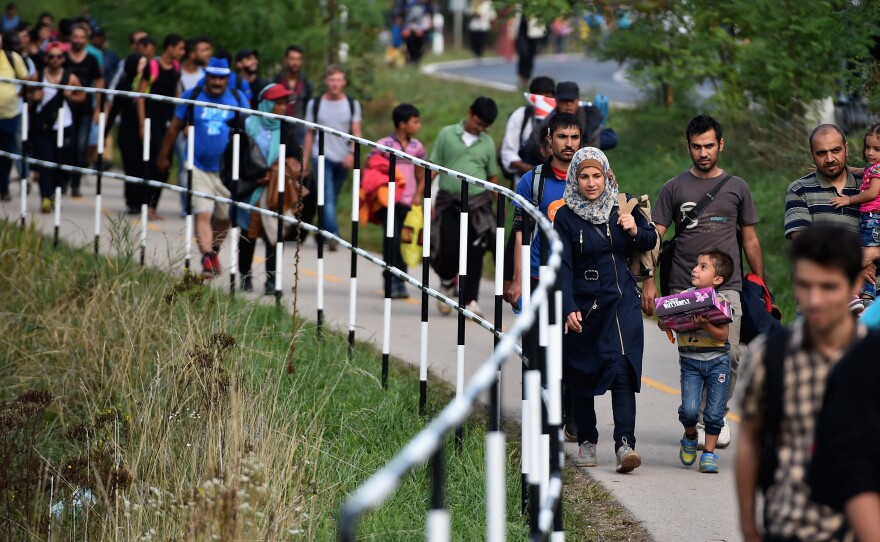 Hundreds of migrants walk to a holding center in Hegyeshalom, Hungary, near the Austrian border.