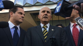 Former Los Angeles County Sheriff Lee Baca, center, talks to members of the media as he walks out of a federal courthouse downtown Los Angeles on Thursday, Dec. 22, 2016. 