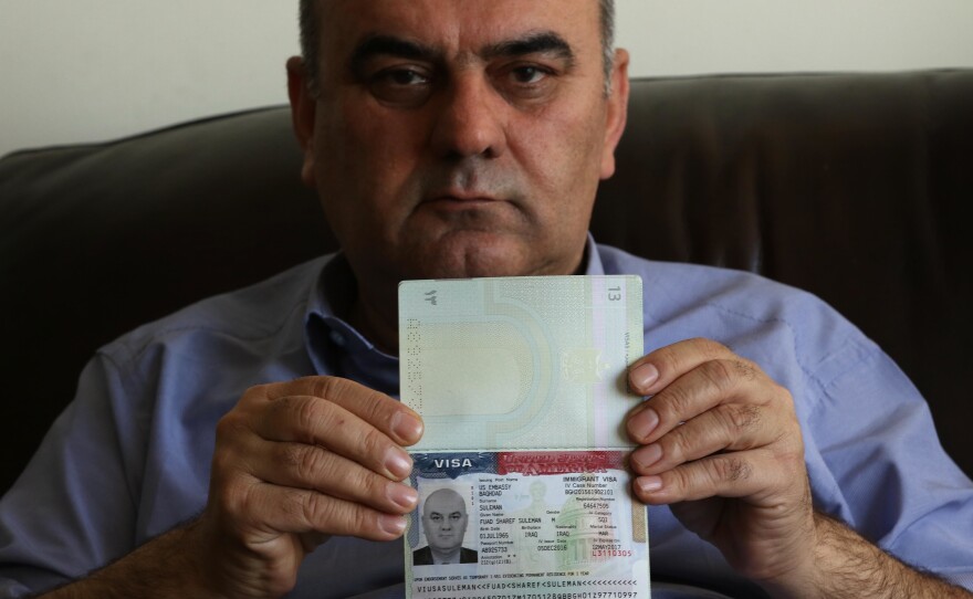 Fuad Sharif Suleman shows his U.S. immigrant visa in Erbil, Iraq, on Jan. 30, after returning to Iraq from Egypt, where he and his family were prevented from boarding a plane to the U.S. following President Trump's decision to temporarily bar travelers from seven countries, including Iraq.
