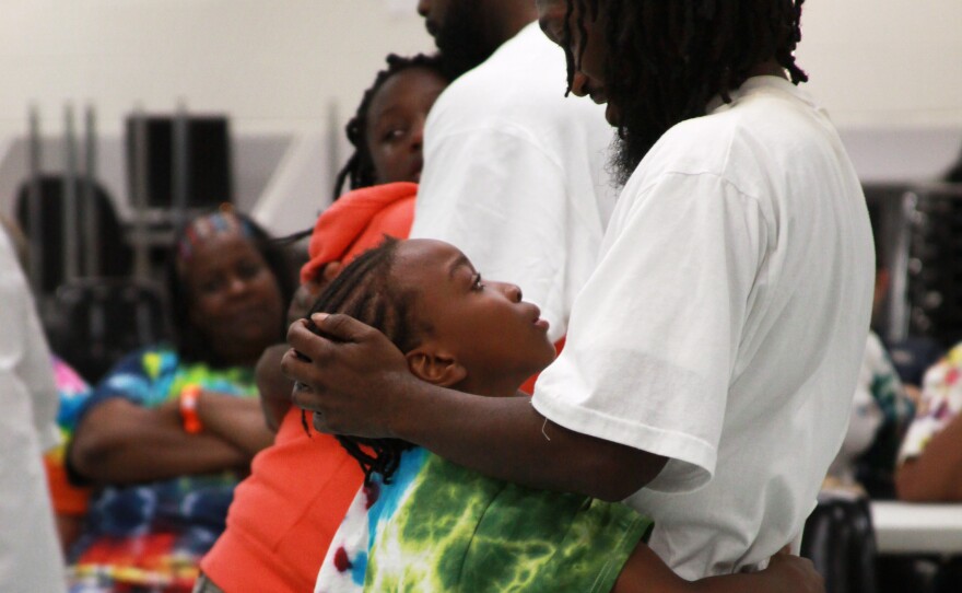 The youngest camper, 9-year-old Jeremiah Ben, shares one last hug with his dad, Bruce Ben, before it's time to go home.