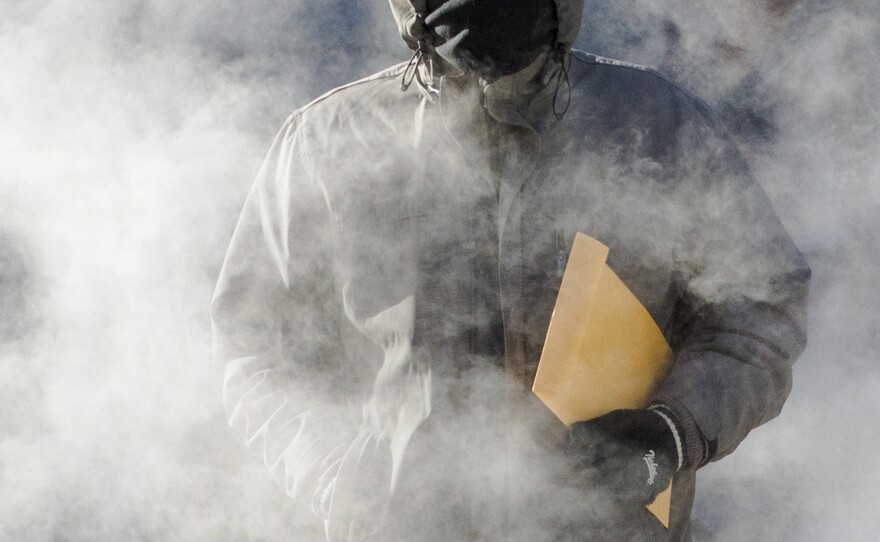 A man walks through a steam cloud in frigid cold temperatures Tuesday in Manhattan.