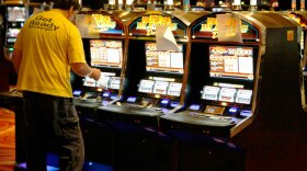 A technician looks over a slot machine at the new Rivers Casino in Pittsburgh in late July. The casino opened in early August, part of an increasing expansion of casino gambling in states.