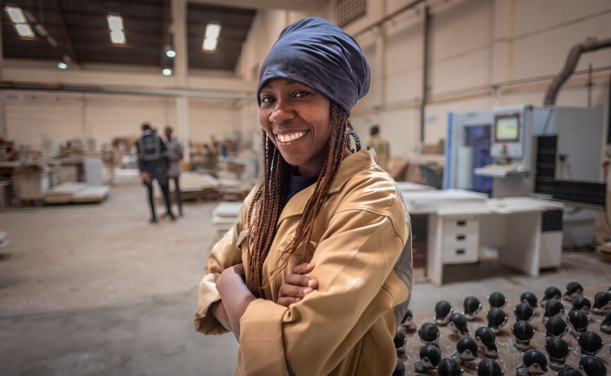 Diana Ojiambi, 24, at her workplace in the Furniture International factory in Nairobi, Kenya. She is one of several former Buildher students who have found work with the company.