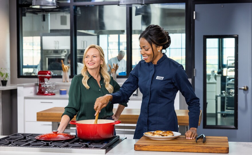 Test cook Erica Turner makes host Bridget Lancaster Chicken Yassa (Senegalese Braised Chicken with Caramelized Onion and Lemon).