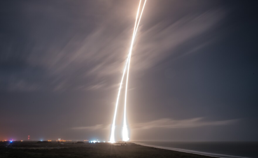 A handout picture made available by SpaceX shows a nine-minute exposure picture of the launch, re-entry and landing burns of SpaceX's Falcon 9 rocket at Cape Canaveral Air Force Station.
