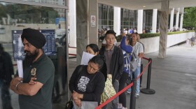 In June 2025, people line up outside the Los Angeles Federal Building, which houses offices for U.S. Immigration and Customs Enforcement and U.S. Citizenship and Immigration Services.