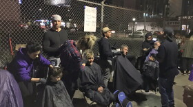 Homeless people getting free haircuts on 15th Street downtown, part of Streets of Hope's Thanksgiving Feed the Homeless event, Nov. 22, 2017.