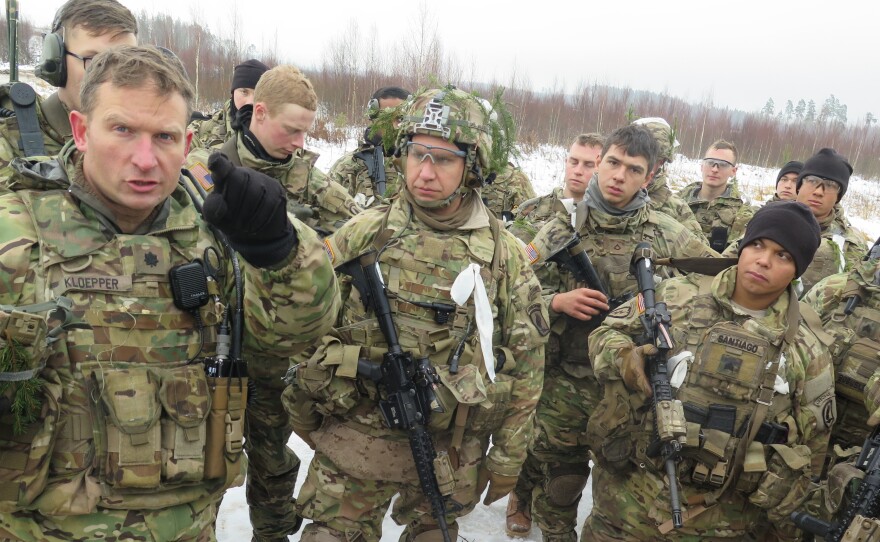 U.S. Army Lt. Col. Mike Kloepper (left), talks with soldiers from the 173rd Airborne Brigade after a live-fire exercise near Tapa, Estonia.