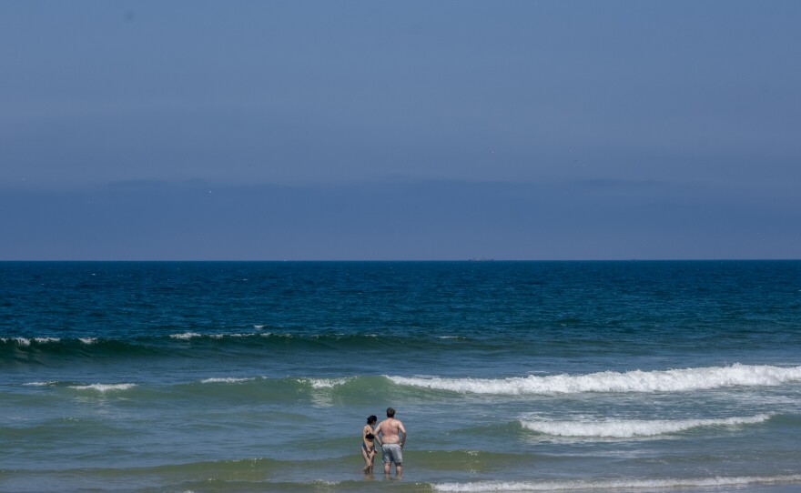 Two people are shown in the water off Imperial Beach on July 18, 2023.