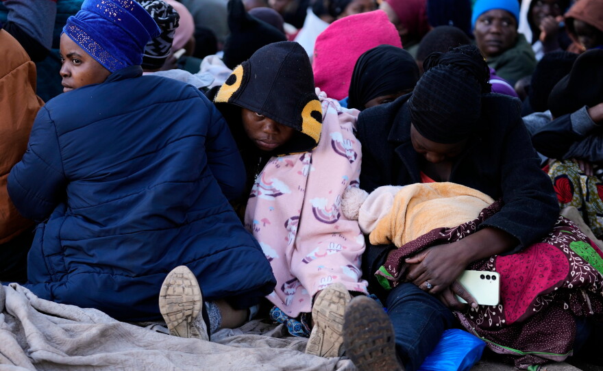 Malawian migrants sit on a driveway ahead of their deportation at a temporary center in Durban, South Africa, on June 19.