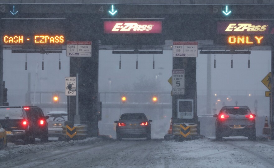 Vehicles are seen at the toll bridge of the Holland Tunnel as snow covers the road during a snowstorm on Feb. 9, 2017, in Jersey City, N.J. More states are turning to tolls as a way to fund long-standing transportation needs.