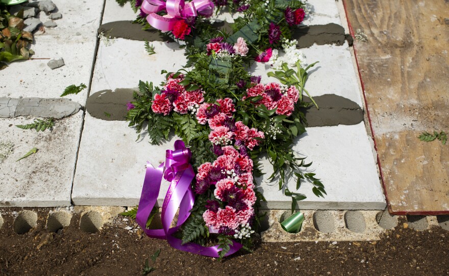 Floral arrangements on Irizarry's tomb at the Remanso de Paz Municipal Cemetery in Camuy. "She wanted to be buried near her mother and father," her son said. He laments not being able to fulfill that final wish.