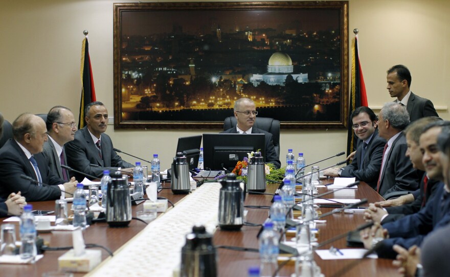 Palestinian Prime Minister Rami Hamdallah, center, leads the first Cabinet meeting of the new Palestinian unity government in the West Bank city of Ramallah on Tuesday.