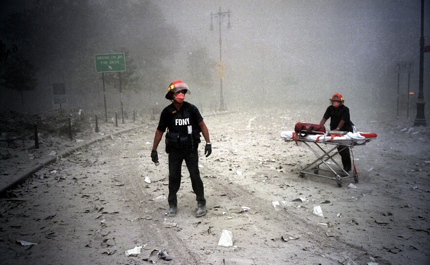 Near the Brooklyn Bridge, paramedics with the Fire Department of New York walk toward the scene of the attack.