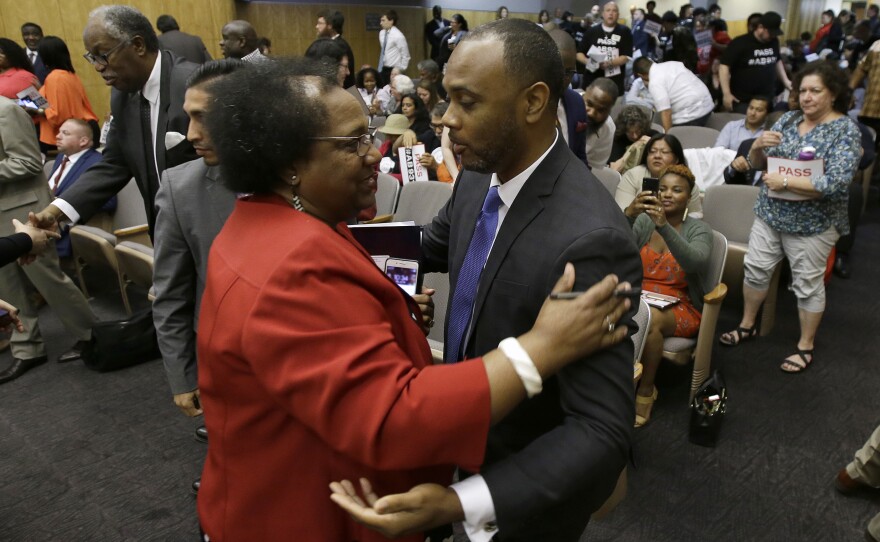 Assemblywoman Shirley Weber, D-San Diego, is congratulated by Pastor Les Simmons after her bill to limit police use of deadly force was approved by the Senate Public Safety Committee, Tuesday, June 19, 2018, in Sacramento, Calif.