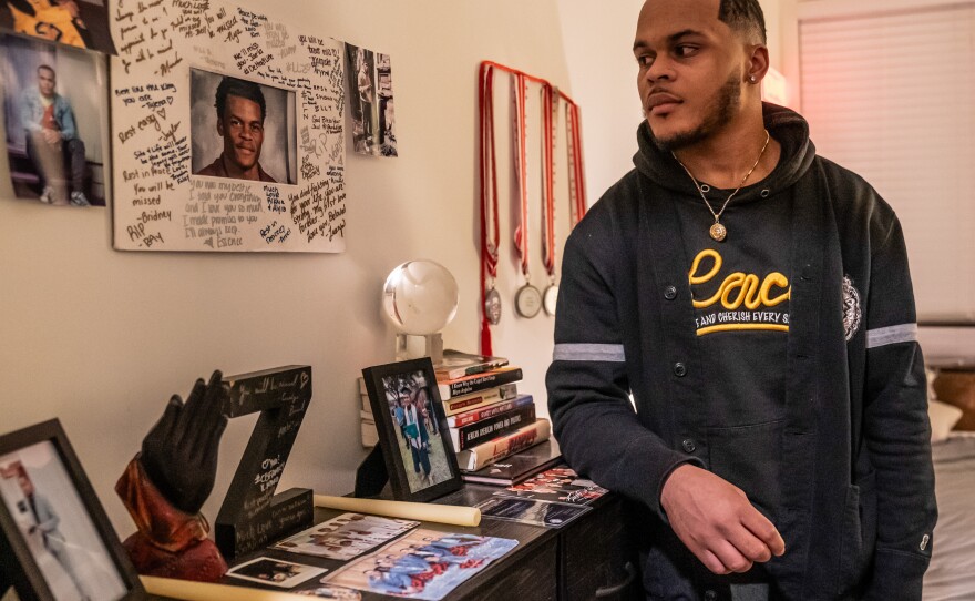 In his bedroom, Zion Kelly keeps his brother's memory alive by displaying photos of them in happier times.