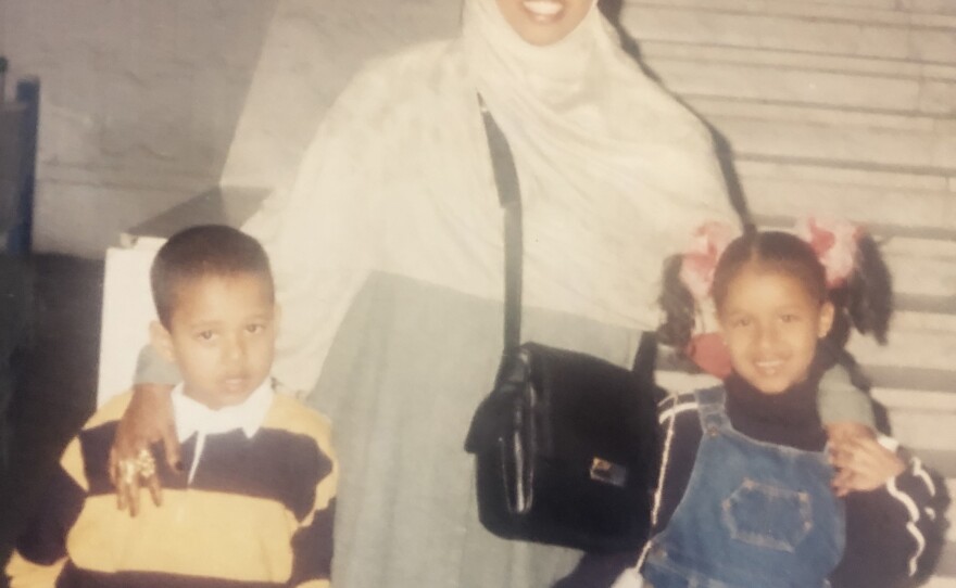 A young Faiza Warsame and her brother Israel take a picture alongside their aunt Faduma Ahmed at the airport in Cairo before starting their journey to San Diego.