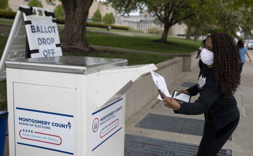 An Ohio voter drops off her ballot at the Board of Elections in Dayton earlier this week. Legal fights around mail-in voting are heating up as states turn to the practice amid the coronavirus pandemic.