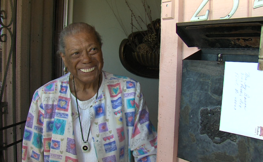 A District 4 voter opens her door to greet Myrtle Cole while she campaigns.