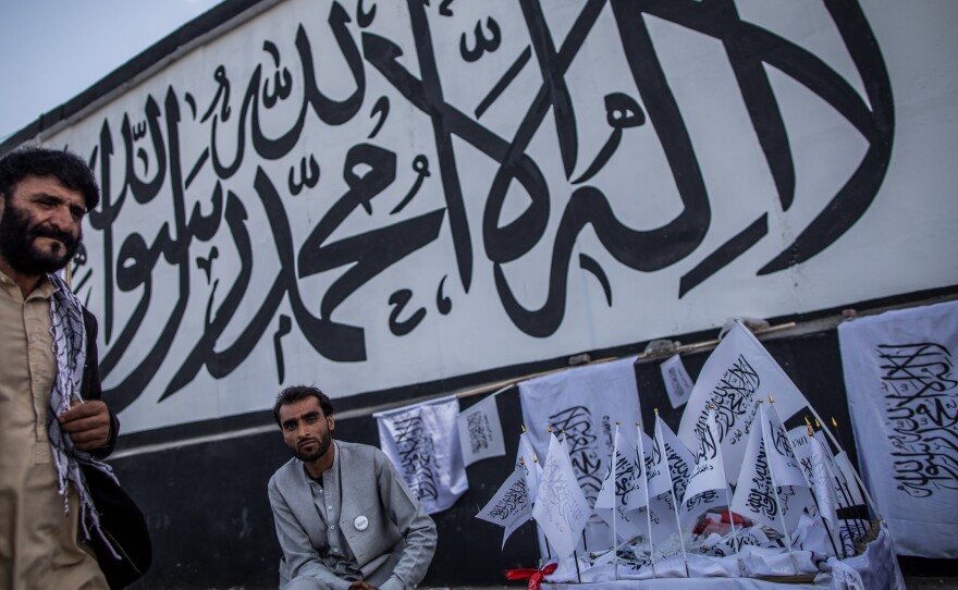 A man sells Taliban flags imprinted with the Muslim creed in Kabul, Afghanistan, on Sept. 24.