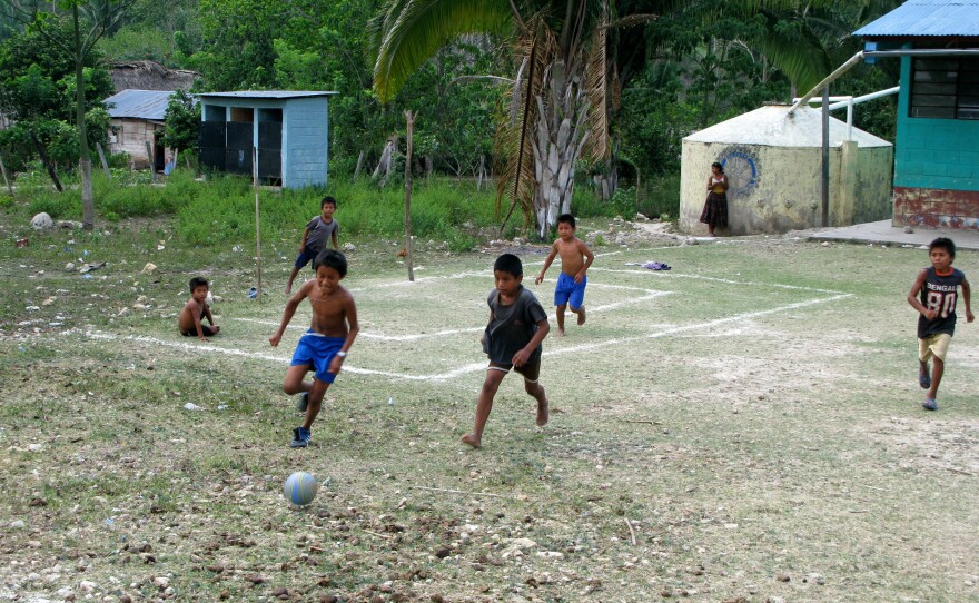 Football on a makeshift field in Limon, Guatemala.