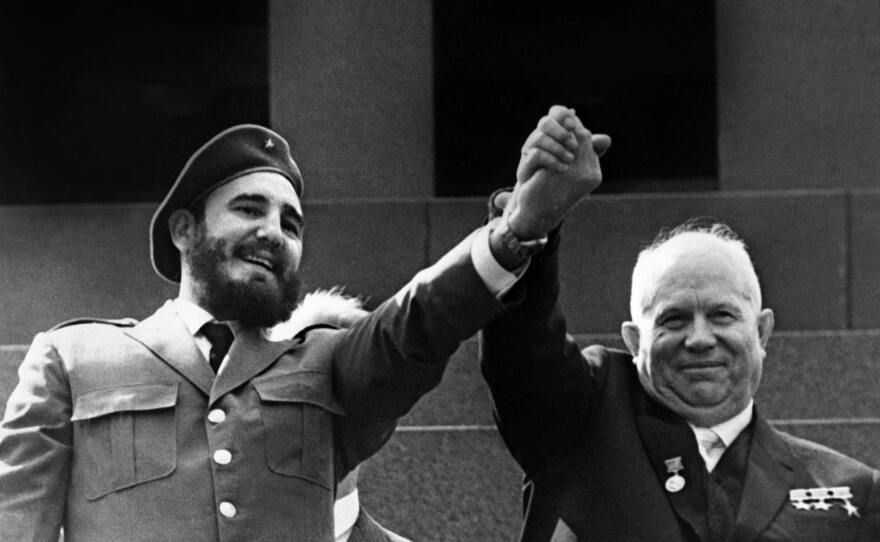 Castro holds the hand of Soviet leader Nikita Khrushchev during a four-week official visit to Moscow in May 1963.