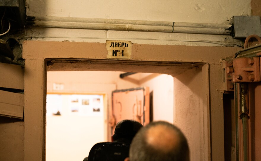 People walk through one of the doors into a government bunker for essential workers in Kyiv.