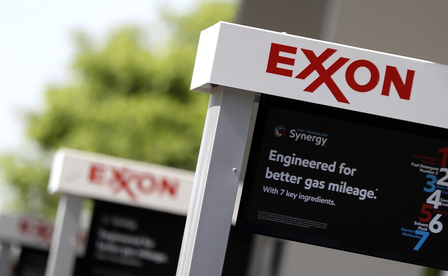 This April 25, 2017, file photo, shows Exxon service station signs in Nashville, Tenn.