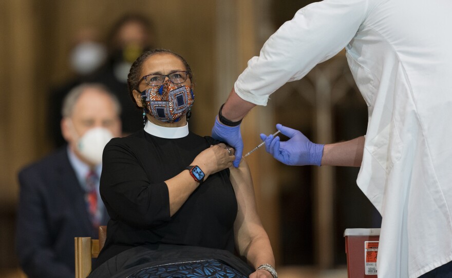 A pastor is administered with the Johnson & Johnson COVID-19 vaccine in May, during a gathering of a group of interfaith clergy members, community leaders and officials at the Washington National Cathedral, to encourage faith communities to get the COVID vaccine.