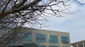 Bare branches sit in the foreground of the UC San Diego's Moores Cancer Center, Jan. 16, 2020.