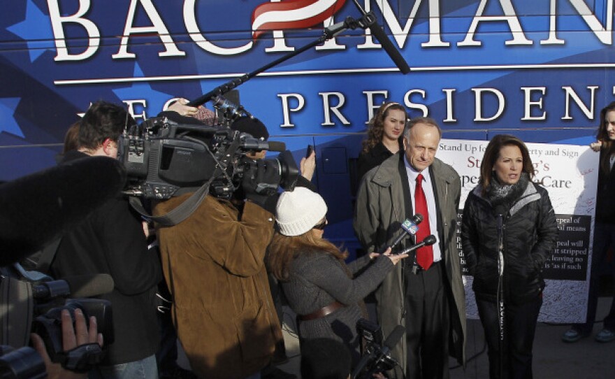 Republican presidential candidate Michele Bachmann (center) talks to the media after a campaign stop Tuesday at Valley High School in West Des Moines, Iowa.
