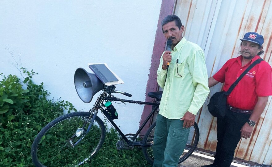 Venezuelan evangelical pastor Wenceslao Méndez draws people to his sermons from his bike using a speaker system.